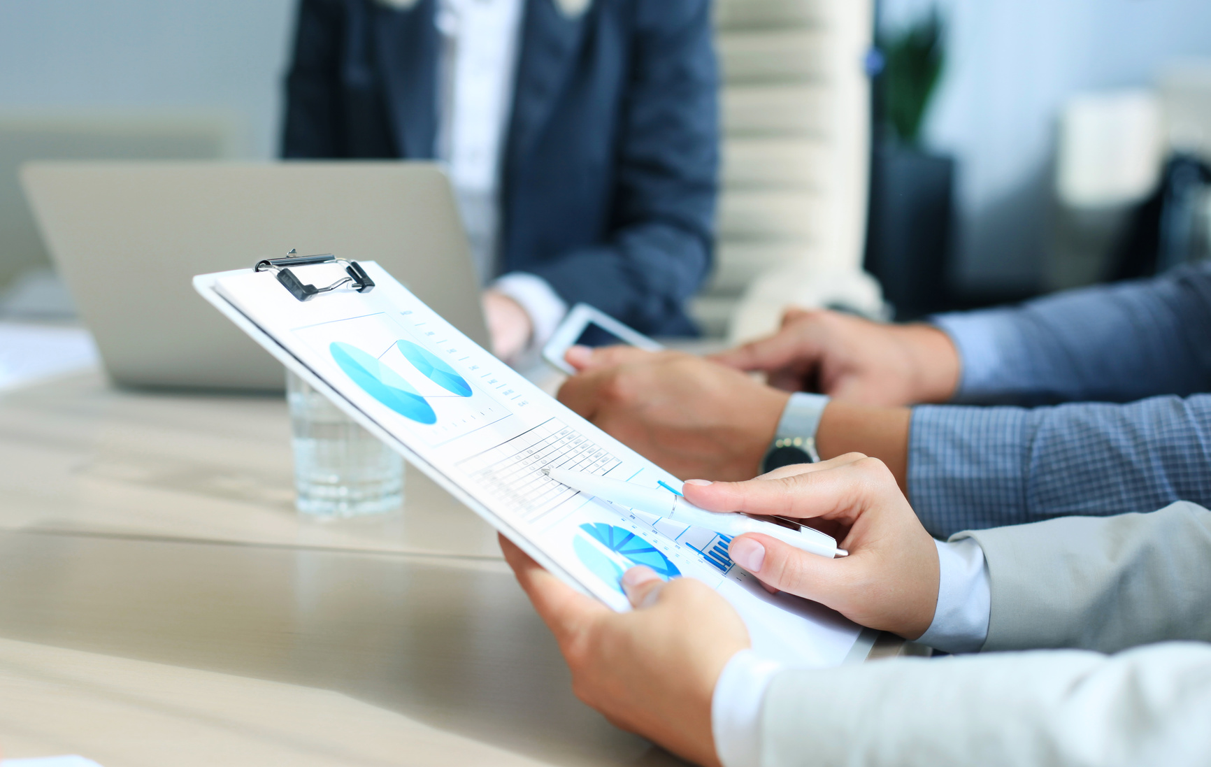 Close-up of graphs and charts analyzed by businesspeople