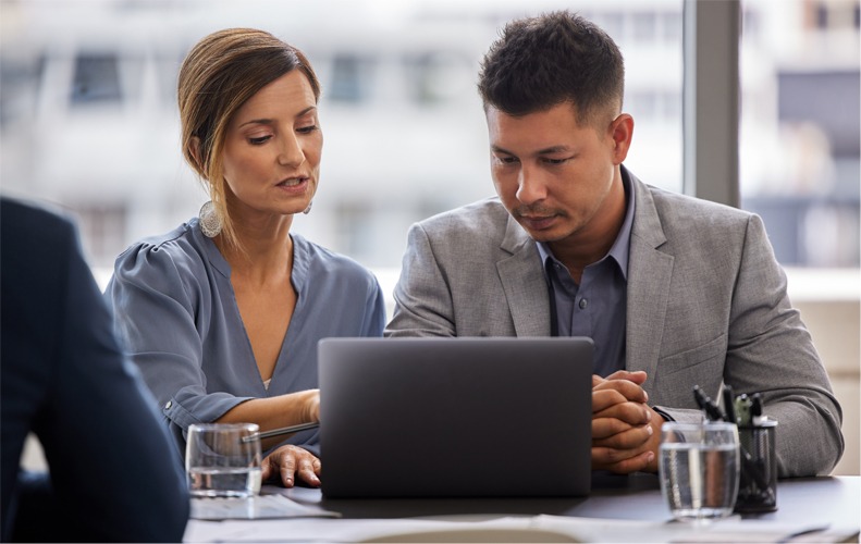 Man, woman and business with laptop for coaching in meeting, discussion for development or growth. People, teamwork and computer in boardroom for company with pitch, discussion for online marketing